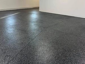 Epoxy-coated garage floor with durable, high-gloss finish, ideal for residential and commercial spaces.