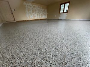 Professional epoxy floor coating in a residential garage, providing a durable, attractive, and easy-to-clean surface. Perfect for home garages needing a high-quality finish.