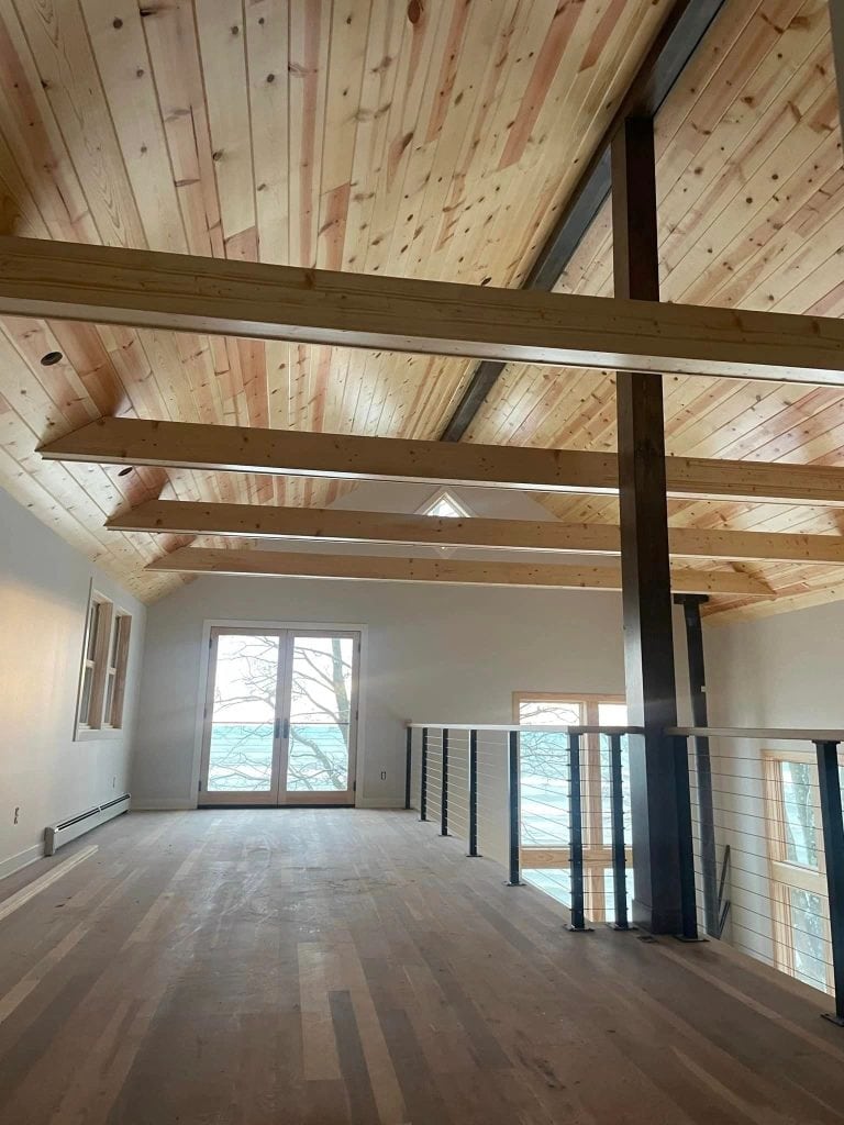 Elegant interior featuring a wooden ceiling with exposed beams and a spacious open-plan layout, perfect for contemporary home decor and renovation projects.